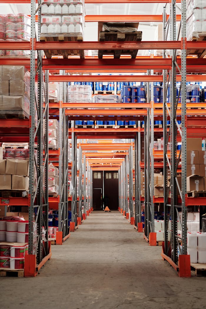 services-01 A modern warehouse interior showcasing organized shelves and pallets for efficient storage.